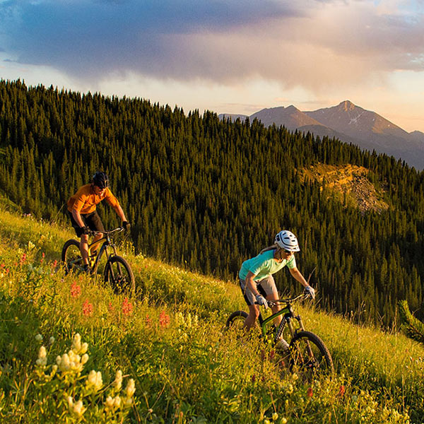 people biking down a hill